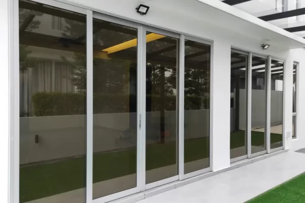 sliding doors on patio with glass coastal home